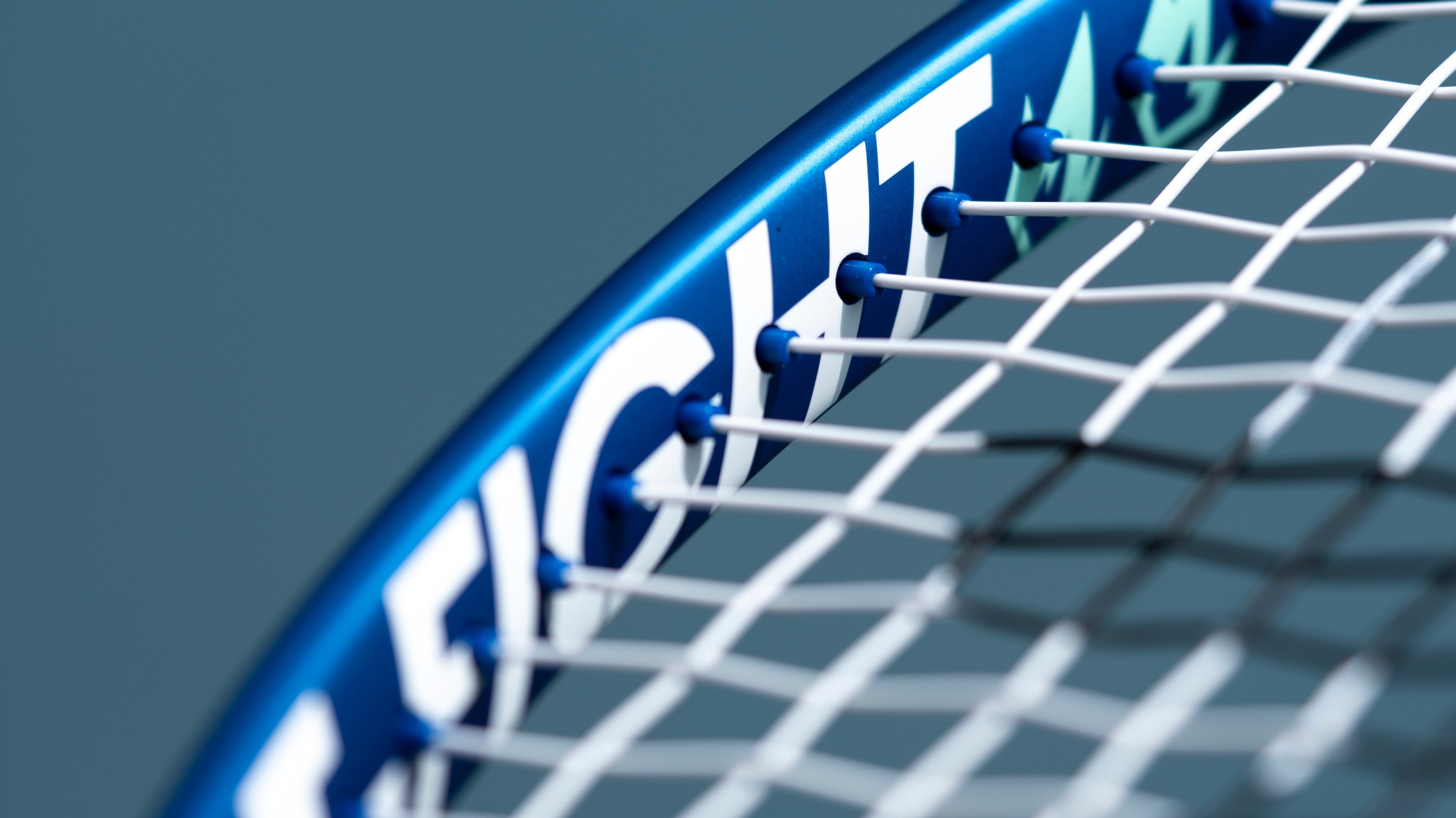 Macro shot of tennis strings and frame