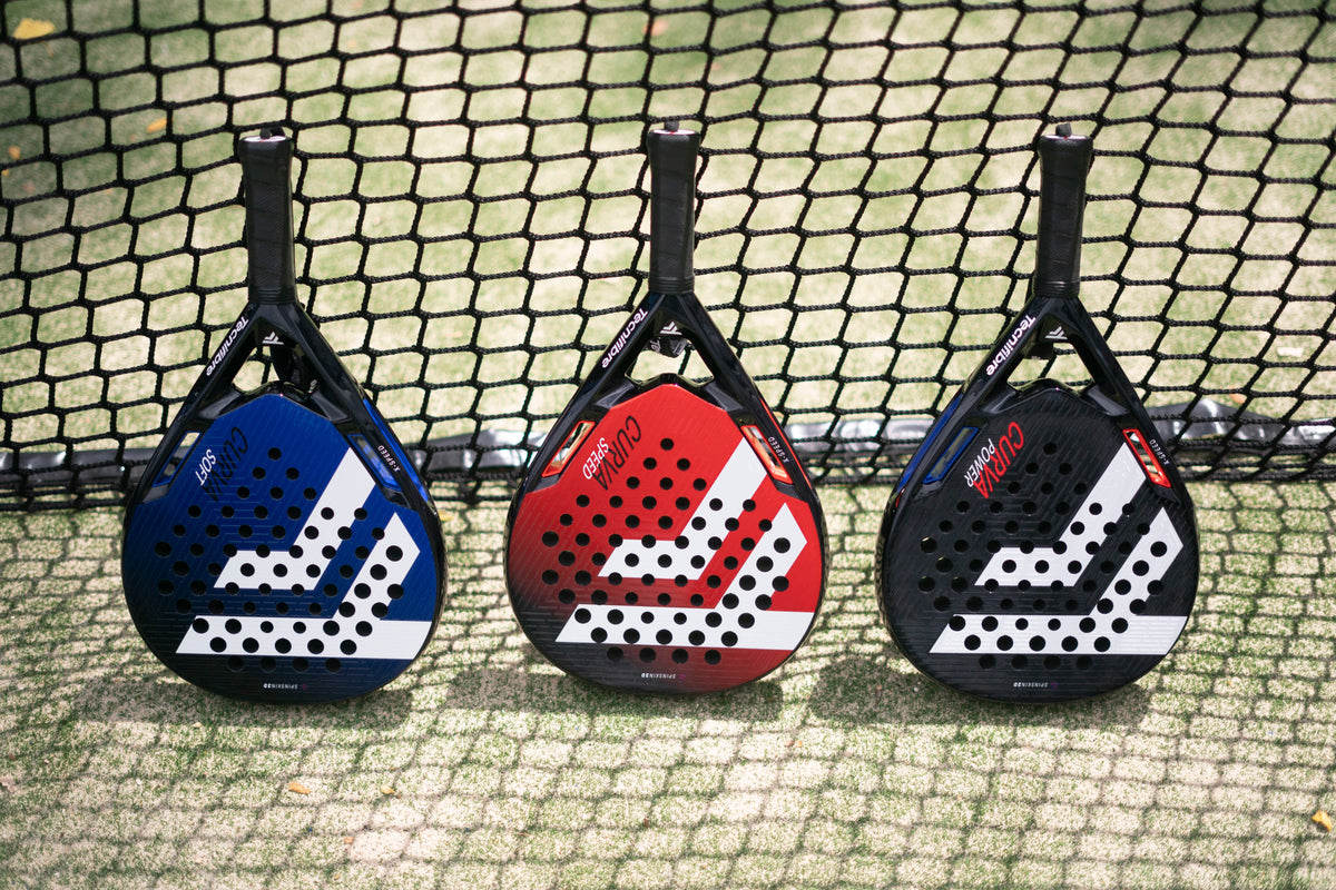 Three Tecnifibre Curva padel rackets against the court net